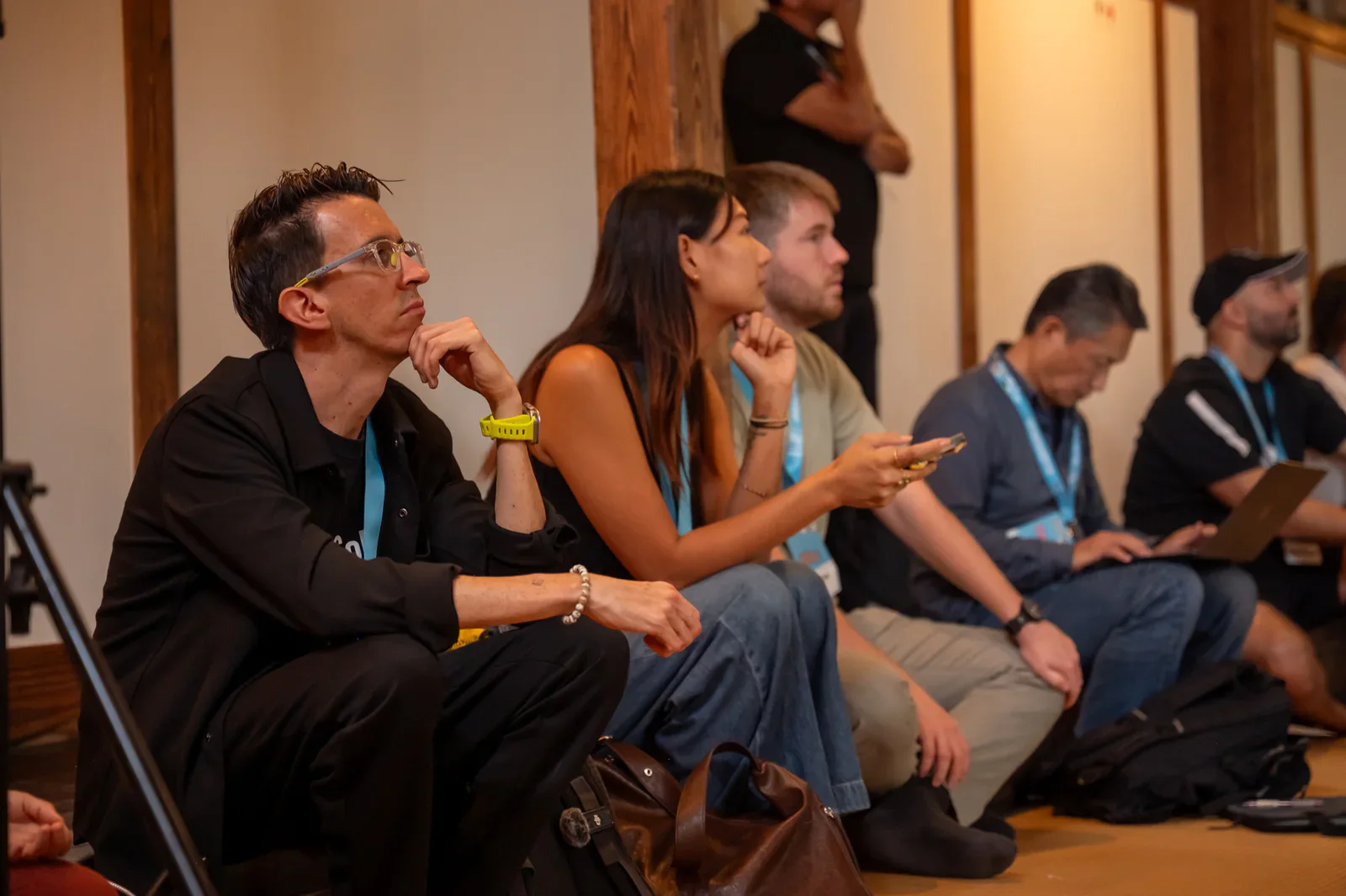 Participants listening closely to a speaker at Colive Fukuoka Summit